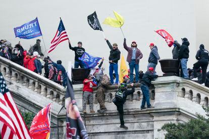 Rioters wave flags on the West Front of the U.S. Capitol in Washington