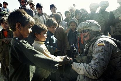 A Spanish soldier speaks to some children during a joint foot patrol with the Afghan army in the area of Zargar.