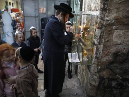 An Orthodox Jew lights a candle on the second night of Hanukkah in Jerusalem.
