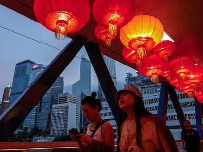 Red lanterns are seen hanging on the pedestrian footbridge as decorations for the celebration of National Day, in the financial central district of Hong Kong, China October 3, 2023.