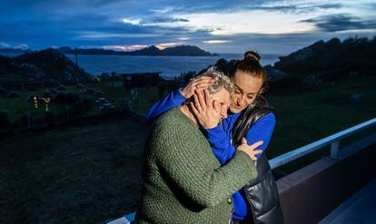 Gloria Padín Costas, sister of Captain Juan Enrique Padín and mother of Eduardo Rial Padín, hugs her son's girlfriend Sara Prieto after hearing they were among the survivors of the shipwreck.