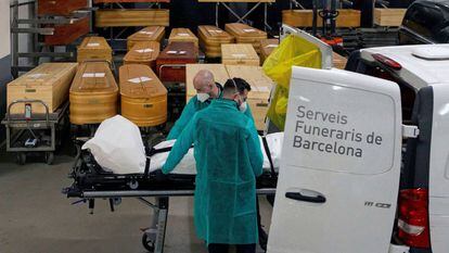 Funeral workers transferring the remains of a Covid-19 victim in Barcelona.
