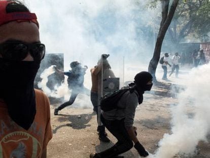 Demonstrators throw tear gas canisters back at security forces on Wednesday in Caracas.
