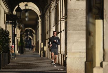 A man jogs in Paris, France, where members of the public can go out onto the street for an hour of physical activity a day under lockdown rules.