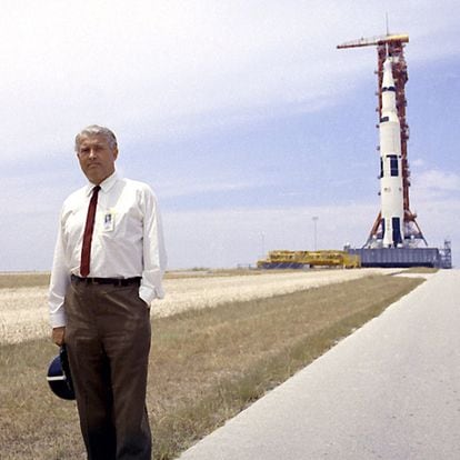 Von Braun poses with the Saturn V launch vehicle in the background. It was going to be used in the Apollo 11 mission.