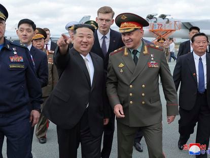 In this photo provided by the North Korean government, North Korean leader Kim Jong Un, center left, with Russian Defense Minister Sergei Shoigu, center right, visits an airport to see military aircrafts near the port city of Vladivostok in the Russian Far East, on Saturday, Sept. 16, 2023.
