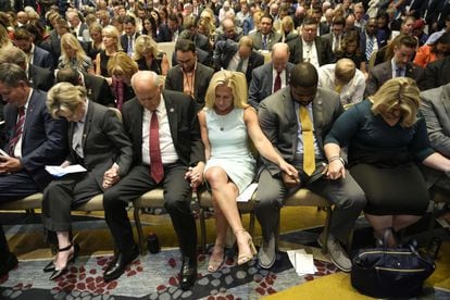 Representatives Louie Gohmert and Marjorie Taylor Greene join other Trump supporters in prayer at the America First Agenda convention in June.