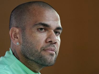 Soccer player Dani Alves listens to a question during a press conference in Doha, Qatar, on Dec. 1, 2022.