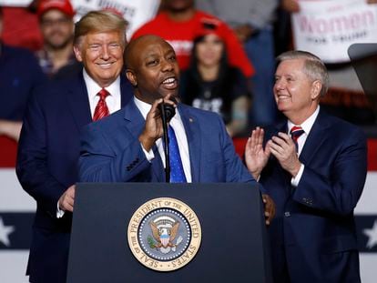 Sen. Tim Scott speaks in front of President Donald Trump and Sen. Lindsey Graham during a campaign rally, on February 28, 2020, in North Charleston, South Carolina.