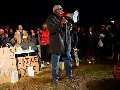 Rev. Andre E Johnson, of the Gifts of Life Ministries, preaches at a candlelight vigil for Tyre Nichols, who died after being beaten by Memphis police officers, in Memphis, Tenn., Thursday, Jan. 26, 2023. Behind at left are Tyre's mother RowVaughn Wells and his stepfather Rodney Wells.