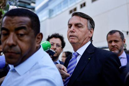 Former President Bolsonaro speaks to the media as he leaves Federal Police headquarters in Brasília; October 18, 2023.