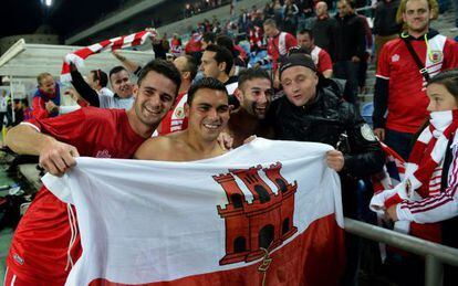 Gibraltar midfielder Robert Guilling (second left) and teammates celebrate with supporters after holding Slovakia in Portugal. 