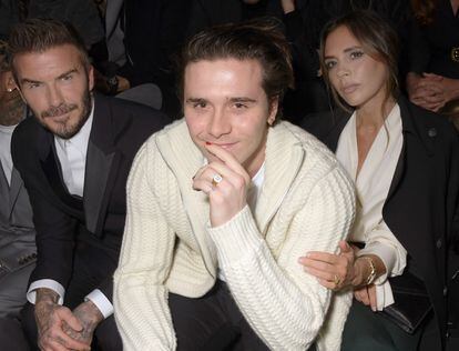Brooklyn Beckham with his parents, David and Victoria, pictured in Paris in a file photo from January 2020.
