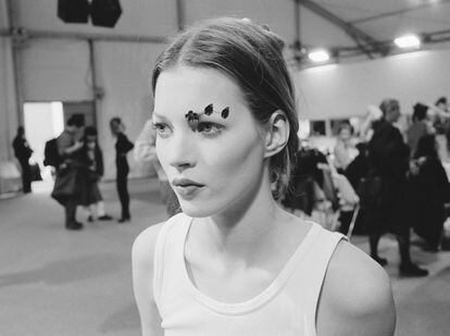 Kate Moss backstage at a fashion show in 1991.