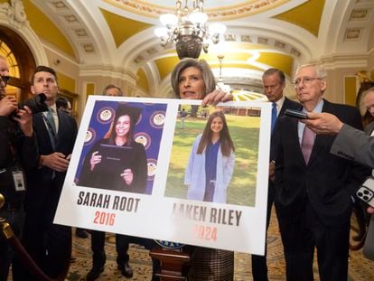 Sen. Joni Ernst, R-Iowa, holds a poster with photos of murder victims Sarah Root and Laken Riley as she speaks on Capitol Hill, Feb. 27, 2024, in Washington.