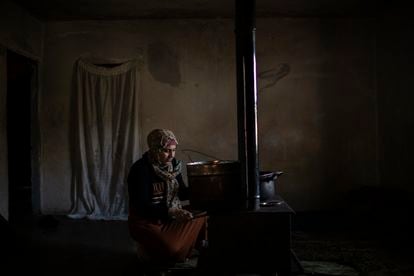 Amina, a Syrian refugee living in the North of Lebanon, heats water using a stove in her house.
