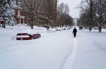 Daniel Shafer of Buffalo, NY, walks along a path in the street in the Elmwood Village neighborhood on December 26.