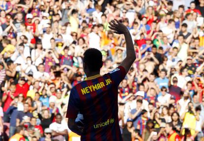 Brazilian striker Neymar waves to Barcelona fans at his presentation at the club.