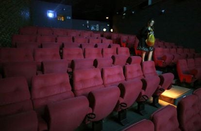 A woman leaves Madrid&#039;s Renoir Cuatro Caminos movie theater, which closed on Monday.