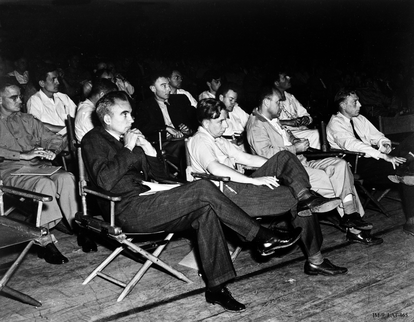 Manhattan Project scientific director Robert Oppenheimer and his colleagues attend a talk at Los Alamos National Laboratory. 