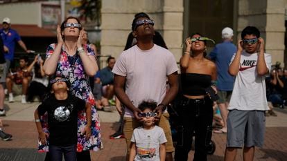 Viewers use special glasses to watch as the moon moves in front of the sun during an annular solar eclipse, or ring of fire, Saturday, Oct. 14, 2023, from San Antonio.