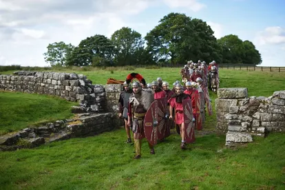 Members of a historical reenactment group cross Hadrian’s Wall, in northern England. 