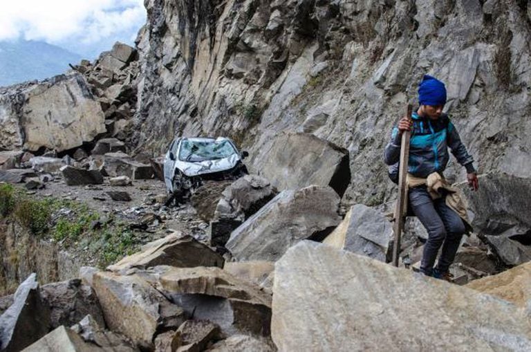 A Nepalese man walks over fallen rocks on the way to Dhunche, a village in Langtang National Park.