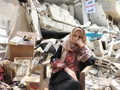 Intisar Muhna in front of her destroyed house in Gaza City.
