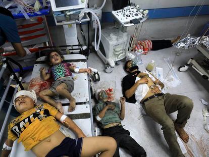 A group of Palestinians injured during an Israeli bombing, including three children, wait to be treated at Al Shifa hospital in Gaza City on November 14.