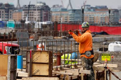 A construction worker prepares a recently poured concrete foundation, Friday, March 17, 2023, in Boston. On Thursday, the Commerce Department issues its third and final estimate of how the U.S. economy performed in the fourth quarter of 2022.