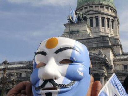 A protestor wears a Guy Fawkes mask during a protest in front of Congress at the time that the Chamber of Deputies was voting on two of six controversial judicial reforms.