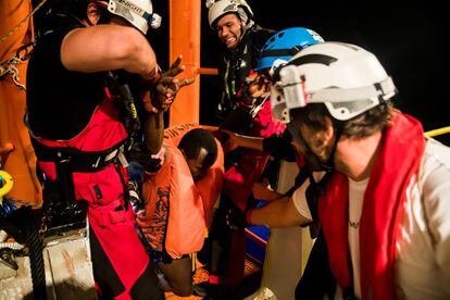 A migrant is helped onto the ‘Aquarius’ by the rescue crew on June 9.