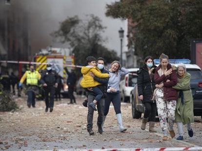Members of the public leave the site of the explosion in Madrid today.