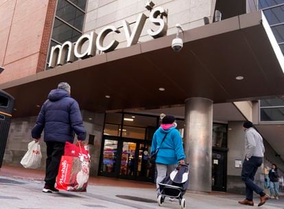 Shoppers walk to the Macy's store in the Downtown Crossing district