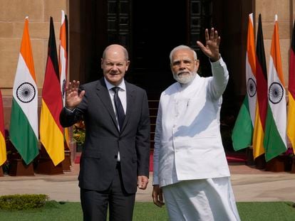 Indian Prime Minister Narendra Modi, right, with German Chancellor Olaf Scholz, wave to media before their meeting in New Delhi, India, Saturday, Feb. 25, 2023. Germany Chancellor Olaf Scholz arrived in the Indian capital on Saturday and he is expected to discuss with the Indian prime minister Russia's war in Ukraine and steps to boost bilateral cooperation in sectors such as renewables, hydrogen, mobility, pharma and digital economy, officials said. (AP Photo/Manish Swarup)