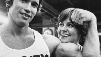 A young Arnold Schwarzenegger shows off his muscles to actress Sally Field, in an image taken in 1976.