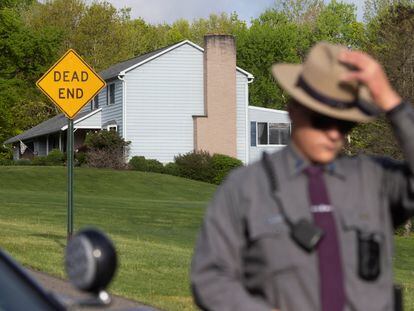 A police officer outside Payton Gendron's house in Conklin.