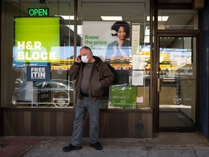 A man waits outside a H&R Block tax preparation office on Monday, April 6, 2020, in the Brooklyn borough of New York. Tax season is here again.