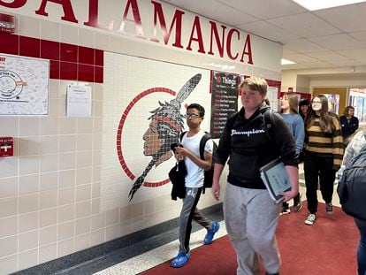 Students walk past a logo that is tiled into the wall at Salamanca High School in Salamanca, N.Y., on April 18, 2023.