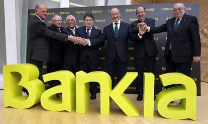 Caja Madrid Chairman Rodrigo Rato (center) in March 2011 with the chiefs of the six other savings banks which made up Bankia. Just over a year after it would be nationalized