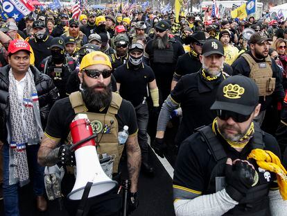 Proud Boys member Jeremy Joseph Bertino, second from left, joins other supporters of President Donald Trump who are wearing attire associated with the Proud Boys as they attend a rally at Freedom Plaza, Dec. 12, 2020, in Washington.