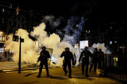 French riot police form a cordon near a cloud of teargas during a demonstration a few days after the government pushed a pensions reform through parliament without a vote, using the article 49,3 of the constitution in Lyon, eastern France on March 20, 2023. 