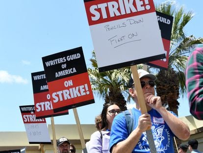 Demonstrators hold signs in front of Paramount Studios