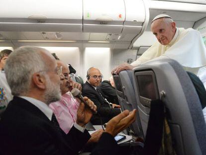 The pope speaks to reporters on his plane Monday while returning to Rome.