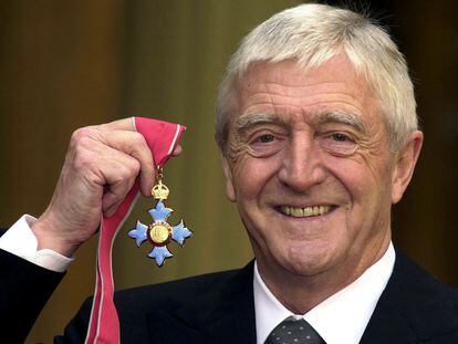 Chat show host Michael Parkinson poses for pictures after he was awarded the Most excellent order of the British Empire (MBE) at Buckingham Palace November 24, 2000.