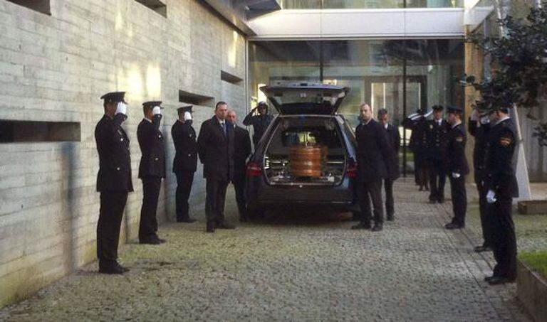 The coffin with the remains of the police officer who died during a shootout with a bank robber on Friday.