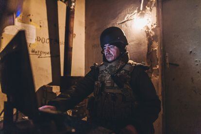 A Ukrainian soldier consults his computer in Marinka, on the outskirts of Donetsk.