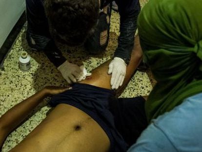 An injured protestor who was shot by Venezuelan security forces on March 30 is given medical assistance.