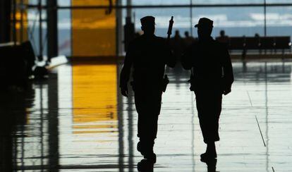 Two police officers patrol Madrid’s Barajas airport.