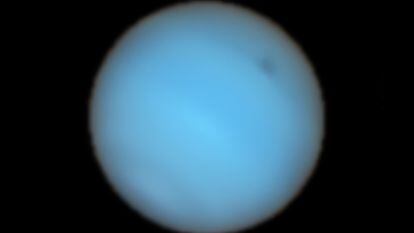 Neptune in an image combining all the colors captured by the telescope, with the dark spot in the upper right.